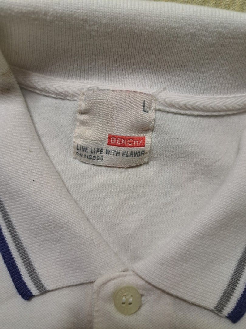 Bench White Polo Shirt Size L (Category: Tshirts & Polo Shirts ) located in Manila. Submitted by sainty.exe (Listing ID 1465455169, Image 2). Description: - Brand: Bench - Color: White with blue and grey ribbed collar and cuffs - Size: Large - Details: Two-button placket closure, small embroidered chest logo - Style: Classic casual, easy to match with jeans or shorts - Condition: Excellent.