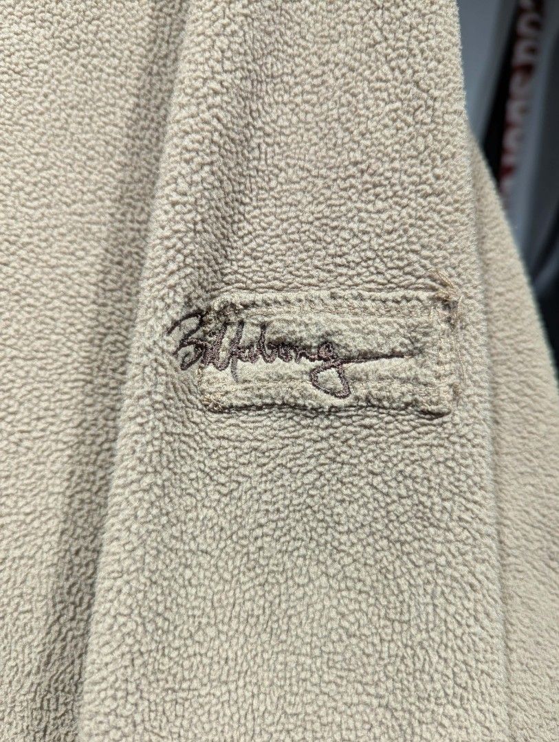 Billabong Beige Quarter Zip Fleece Pullover (Category: Coats, Jackets and Outerwear) located in Manila. Submitted by grandwater.53a8ce (Listing ID 1465488875, Image 2). Description: - Brand: Billabong - Color: Tan - Material: 100% polyester (super soft and warm) - Design: Quarter zip collar with mock neck - Features: Front kangaroo pocket and embroidered sleeve patch - Origin: Made in Taiwan - Condition/Use: Great layering piece for cold weather.