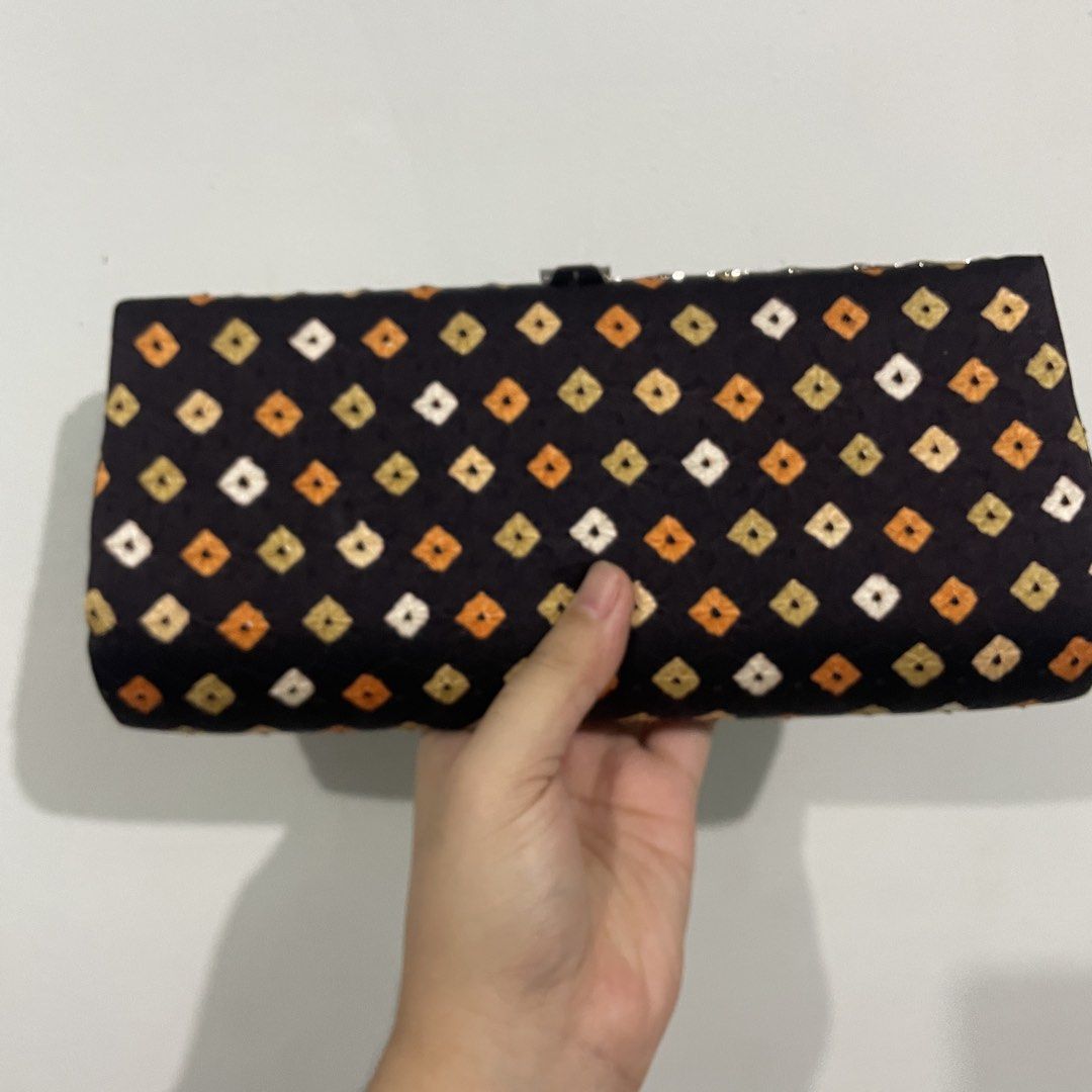 Black and Orange Patterned Clutch Bag (Category: Clutches) located in Las Pinas. Submitted by archivedfinds (Listing ID 1465518062, Image 1). Description: Geometric Clutch. Kisslock closure design. In great condition. RFS: Just stored and not used. Pick-up: Grab/Lalamove arranged by buyer. Delivery: LBC/J&T (shipping within 2 days from payment) MOP: Bank Transfer/Instapay/GCash/Maya .
