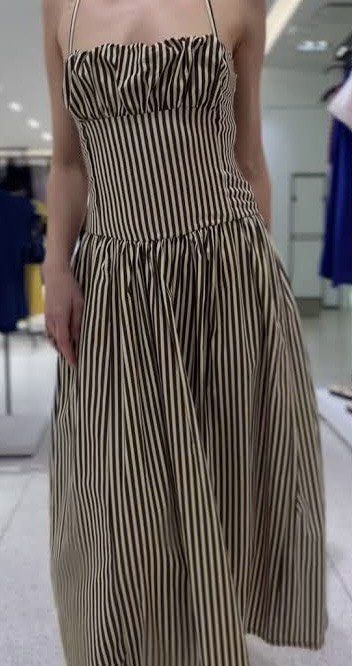 Brown striped midi dress (Category: Dresses) located in Marikina City. Submitted by clutters.of.a (Listing ID 1465577802, Image 1). Description: - Color/Pattern: Classic black and white stripes - Length: Midi (hits around mid-calf) - Design: Square neckline, ruched bodice detail, and flared skirt - Straps: Thin straps - Fabric: Lightweight and breathable for warm weather - Condition: Excellent, no flaws noticed - Style: Easy to throw on for casua