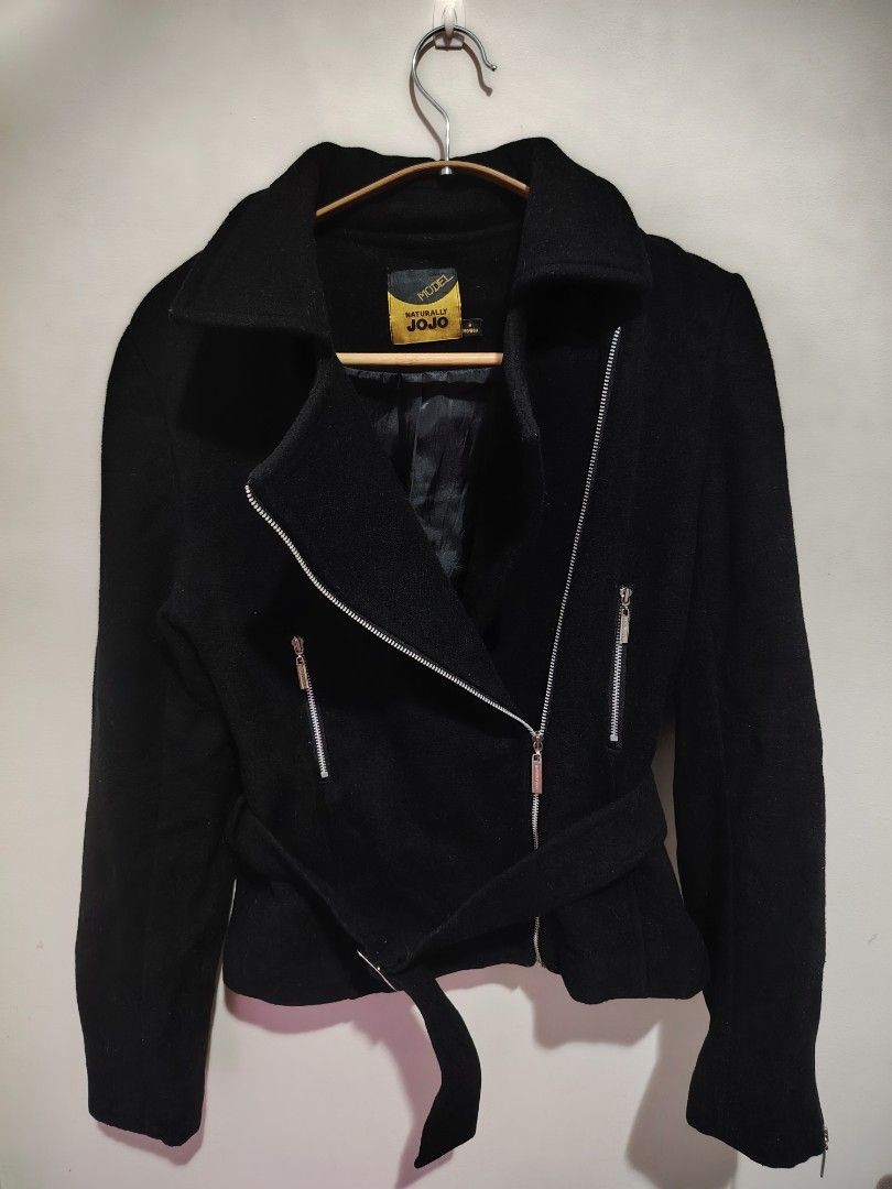 Black Biker Jacket (Category: Coats, Jackets and Outerwear) located in Mandaluyong City. Submitted by declutter_kween (Listing ID 1465527891, Image 3). Description: - Brand: Naturally JoJo - Material: Warm and cozy wool - Size: Medium (structured fit) - Design: Asymmetric front zipper with sleek silver hardware - Pockets: Functional zippered chest pockets - Details: Includes a waist belt and zippered cuffs with a stylish collared neckline.
