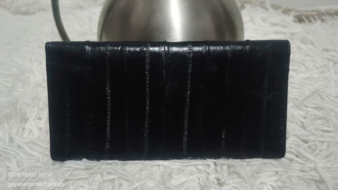 BLACK E EL SKIN LEATHER LONG WALLET/CHECK BOOK (Category: Wallets & Card holders) located in Kalibo. Submitted by secondchances.thriftsh8p (Listing ID 1465536360, Image 2). Description: - Color: Classic black - Design: Slim fold with stylish vertical textured panels - Condition: Clean overall shape with minor edge wear from regular use - Usage: Sleek finish, perfect for daily use and easy to slip into pockets or bags.