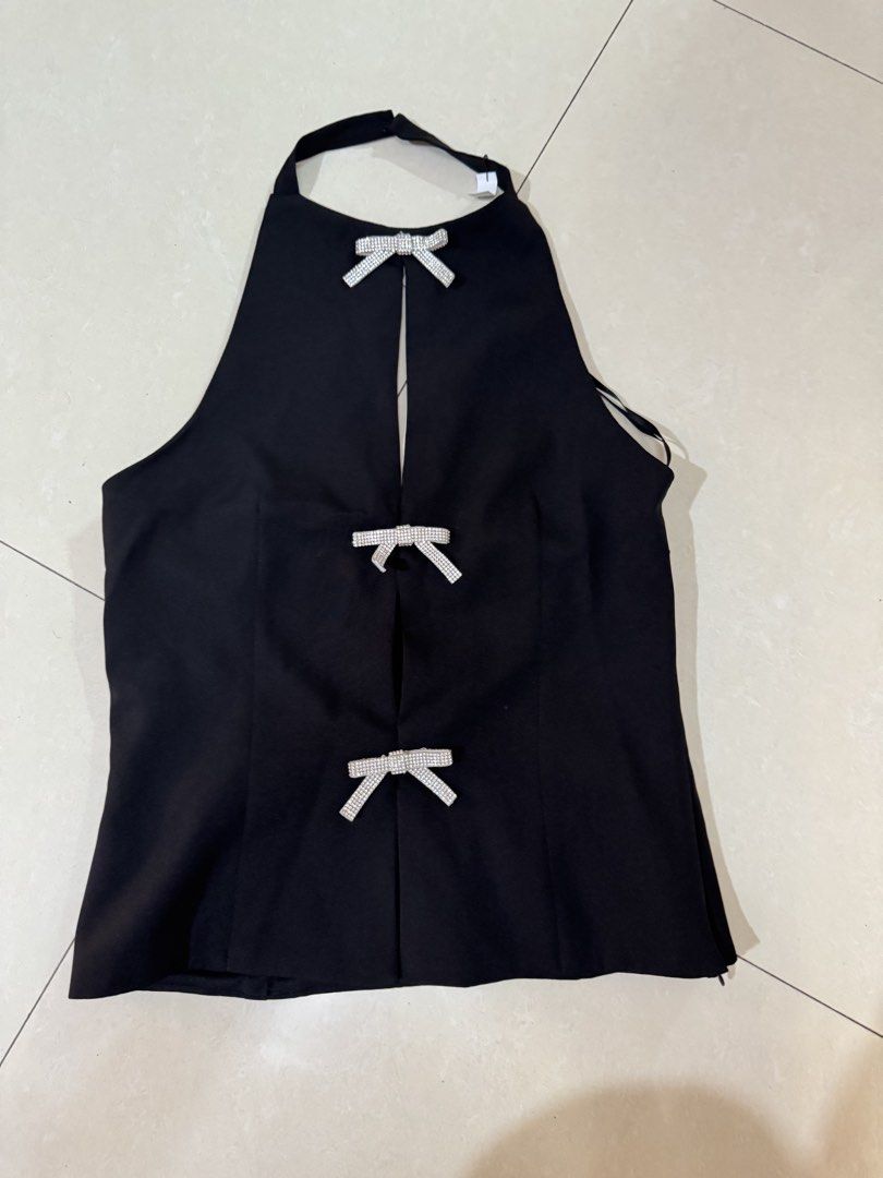 Black Halter Top With Rhinestone Bows (Category: Sleeveless) located in Quezon City. Submitted by sweetlyluxe (Listing ID 1465485669, Image 1). Description: - Color: Sleek black - Design: High neck halter style with vertical front cutout - Accents: Three sparkling rhinestone bows down the front - Closure: Convenient side zipper - Perfect for: Parties, clubbing, and night outs like zara.