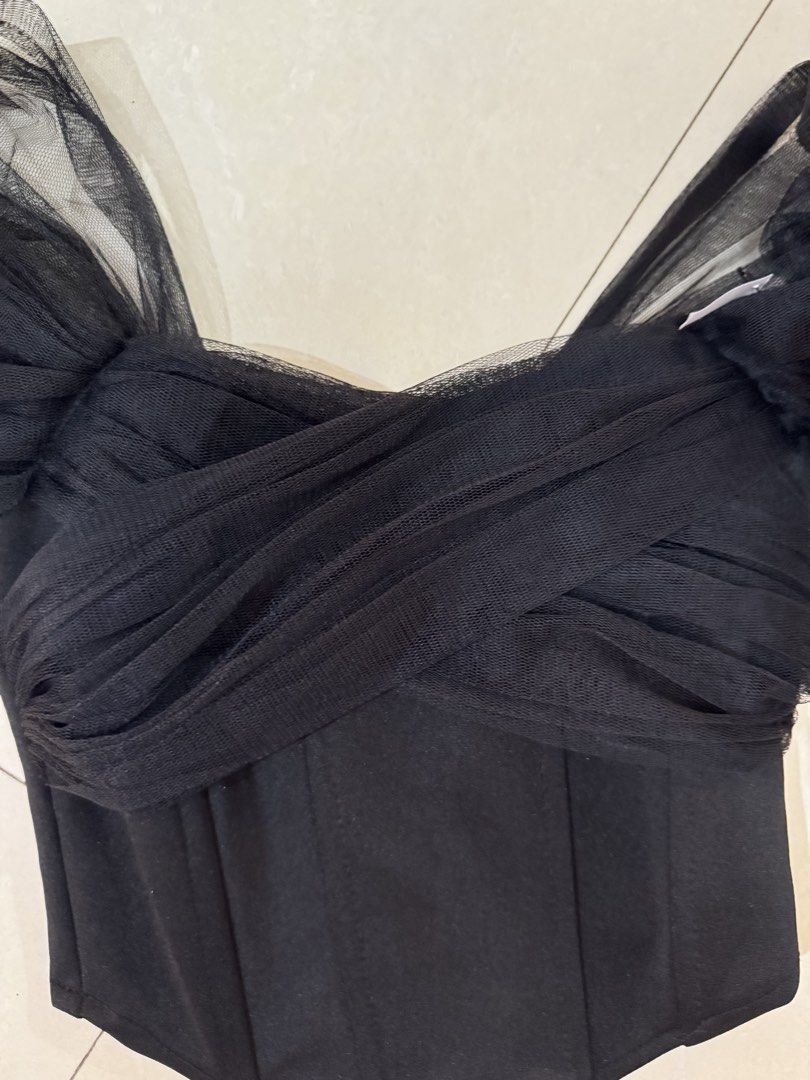 Black Mesh Off Shoulder Corset Top (Category: Sleeveless) located in Quezon City. Submitted by sweetlyluxe (Listing ID 1465486023, Image 2). Description: - Color: Black - Design: Corset top with sheer tulle mesh overlay and draped criss-cross chest - Sleeves: Puffy off-shoulder sleeves - Structure: Built-in boning in the bodice - Closure: Hook and eye closure down the back.