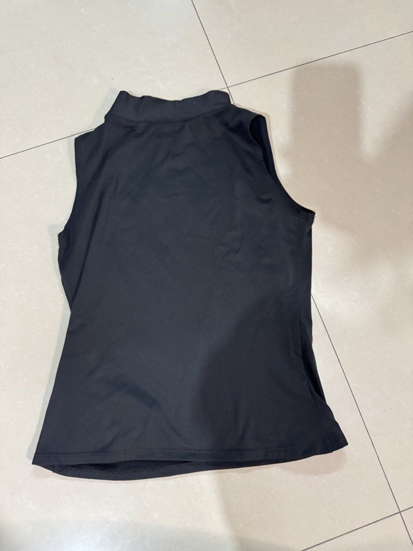 Black Mock Neck Sleeveless Tank Top (Category: Sleeveless) located in Quezon City. Submitted by sweetlyluxe (Listing ID 1465492734, Image 2). Description: - Color: Black - Style: Sleeveless with a chic mock neck collar - Fit: Body-hugging, made from smooth stretch fabric - Finish: Clean hemline all around - Versatility: Essential basic piece, great for layering or wearing on its own.