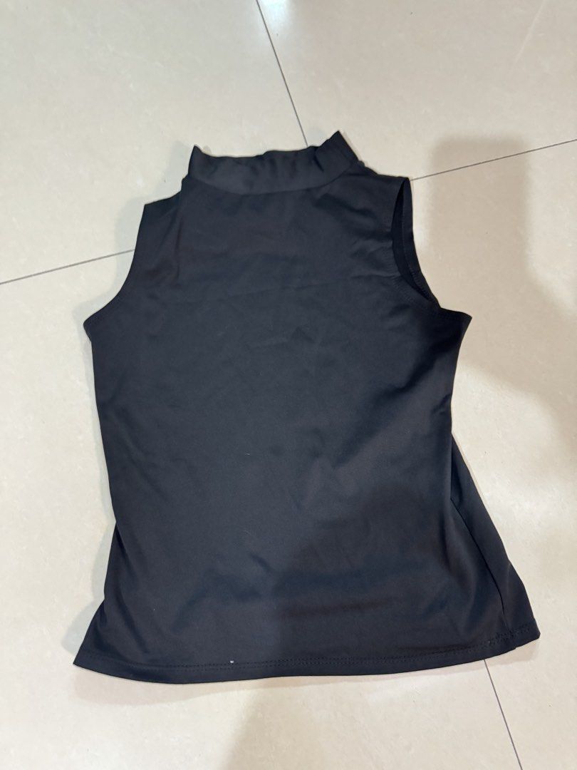 Black Mock Neck Sleeveless Tank Top (Category: Sleeveless) located in Quezon City. Submitted by sweetlyluxe (Listing ID 1465492734, Image 1). Description: - Color: Black - Style: Sleeveless with a chic mock neck collar - Fit: Body-hugging, made from smooth stretch fabric - Finish: Clean hemline all around - Versatility: Essential basic piece, great for layering or wearing on its own.
