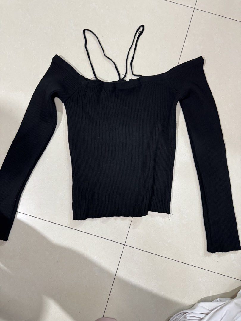 Black Off-Shoulder Ribbed Knit Top with Straps (Category: Sleeveless) located in Quezon City. Submitted by sweetlyluxe (Listing ID 1465491503, Image 3). Description: - Color: Black - Style: Off-shoulder ribbed knit top with long sleeves - Feature: Unique decorative straps around the neckline - Fit: Snug, soft, and stretchy material - Versatility: Perfect for casual daily wear or night outs - Pairing: Easy to style with high-waisted jeans or skirt