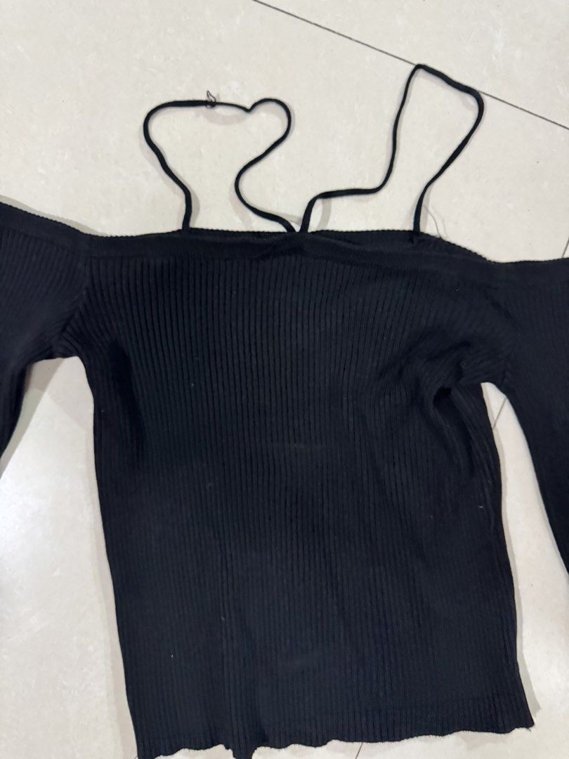 Black Off-Shoulder Ribbed Knit Top with Straps (Category: Sleeveless) located in Quezon City. Submitted by sweetlyluxe (Listing ID 1465491503, Image 2). Description: - Color: Black - Style: Off-shoulder ribbed knit top with long sleeves - Feature: Unique decorative straps around the neckline - Fit: Snug, soft, and stretchy material - Versatility: Perfect for casual daily wear or night outs - Pairing: Easy to style with high-waisted jeans or skirt