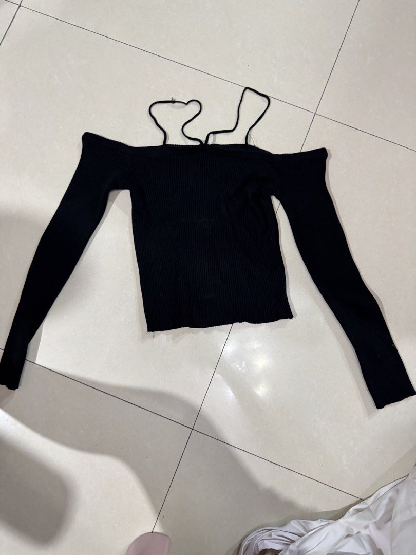 Black Off-Shoulder Ribbed Knit Top with Straps (Category: Sleeveless) located in Quezon City. Submitted by sweetlyluxe (Listing ID 1465491503, Image 1). Description: - Color: Black - Style: Off-shoulder ribbed knit top with long sleeves - Feature: Unique decorative straps around the neckline - Fit: Snug, soft, and stretchy material - Versatility: Perfect for casual daily wear or night outs - Pairing: Easy to style with high-waisted jeans or skirt