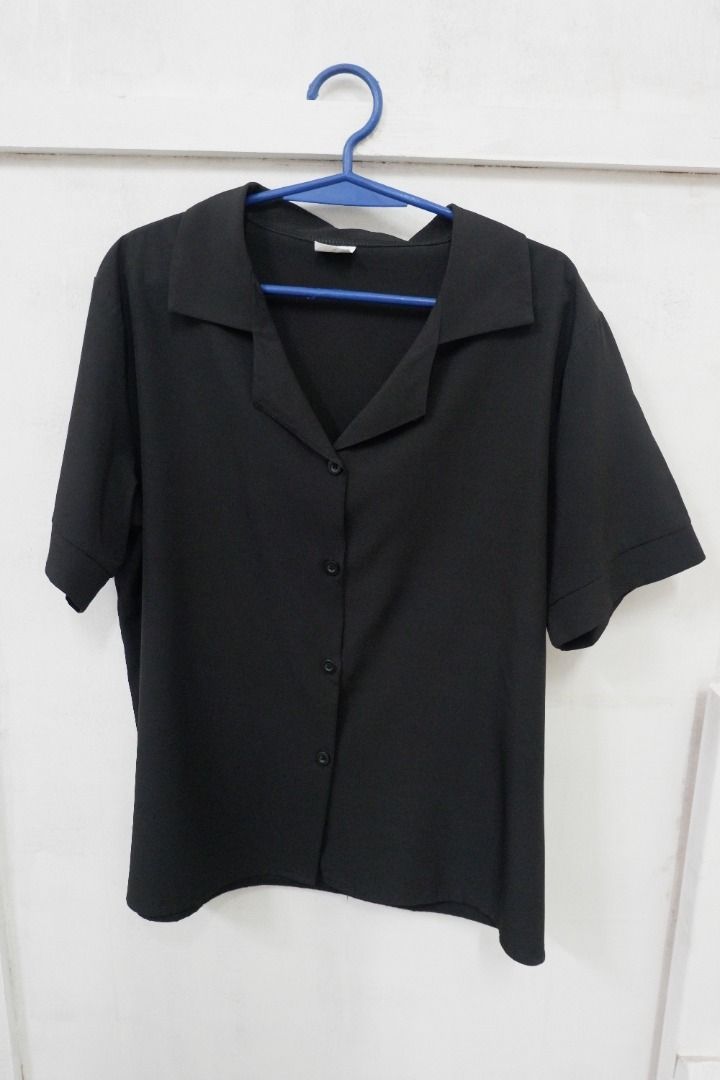 Black Short Sleeve Button Down Blouse Collar Shirt (Category: Blouses) located in Quezon City. Submitted by theusualneed (Listing ID 1465443674, Image 1). Description: - Color: Solid black - Style: Short sleeve button-down with classic camp collar - Fabric: Smooth, lightweight, and very breathable - Details: Four matching front buttons, clean hem and cuffs - Versatility: Easy to pair with any bottoms for casual or work wear.