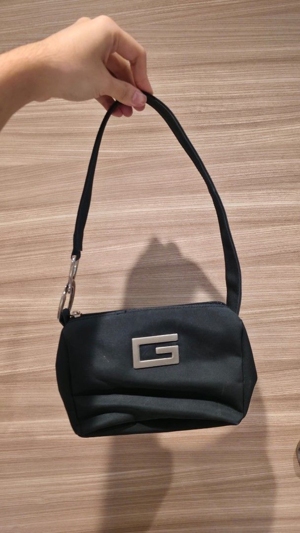 Black shoulder bag with silver logo hardware (Category: Shoulder Bags) located in Taguig. Submitted by destash_ (Listing ID 1465399206, Image 1). Description: - Material: Durable black nylon - Design: Features a striking silver geometric 'G' logo on the front - Closure: Secure top zipper - Strap: Single black strap attached with stylish metallic silver rings - Mode of Payment: GCash, BPI, or COD available - Shipping: Fast nationwide delivery via 