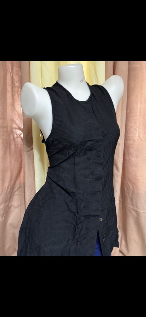 Black sleeveless button-down textured blouse top (Category: Sleeveless) located in Marikina City. Submitted by lorradel (Listing ID 1465393894, Image 2). Description: - small on tag but fits up to medium -Black sleeveless blouse with front button closure. -Textured grid pattern throughout the fabric. -Round neckline and longer tunic -Great basic piece for layering or wearing solo during warmer weather. - might have washable stain due to storage *