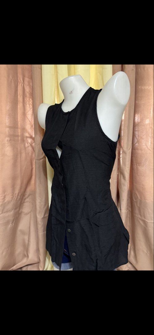 Black sleeveless button-down textured blouse top (Category: Sleeveless) located in Marikina City. Submitted by lorradel (Listing ID 1465393894, Image 3). Description: - small on tag but fits up to medium -Black sleeveless blouse with front button closure. -Textured grid pattern throughout the fabric. -Round neckline and longer tunic -Great basic piece for layering or wearing solo during warmer weather. - might have washable stain due to storage *