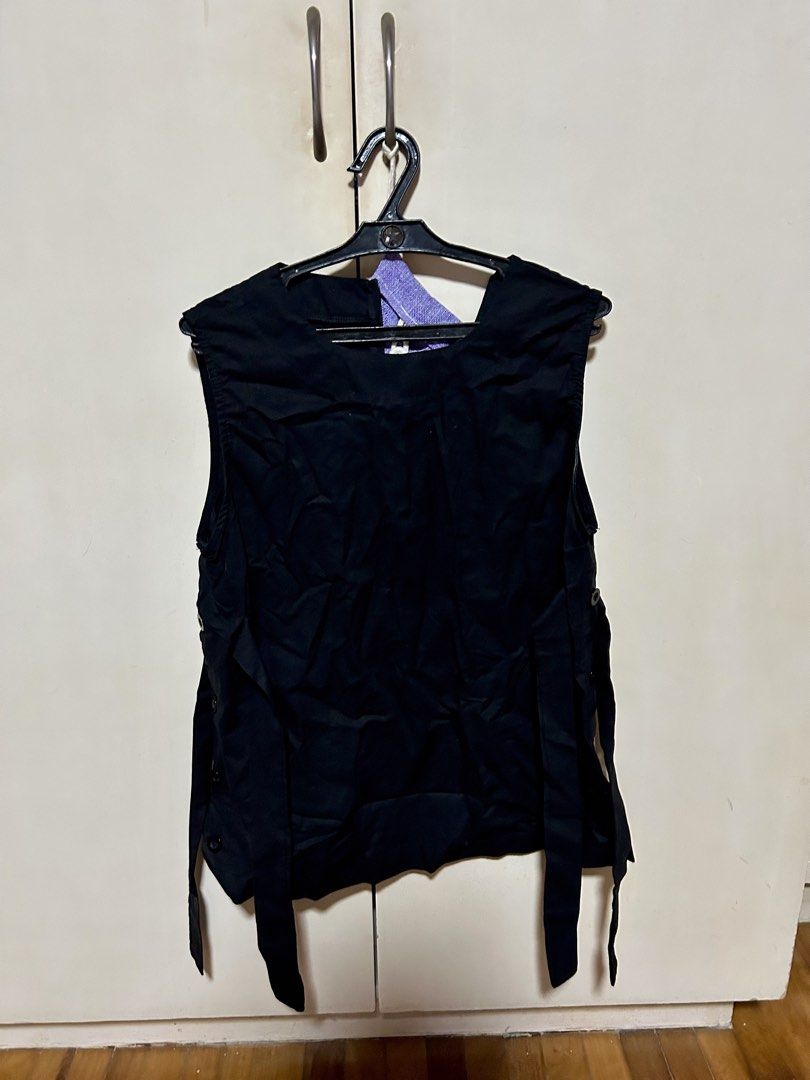Black sleeveless vest with side ties (Category: Sleeveless) located in Makati City. Submitted by monicavazquez (Listing ID 1465485490, Image 1). Description: - Color: Black - Style: Sleeveless layering vest with crew neckline - Detail: Long fabric ties along both sides - Fabric: Lightweight and versatile - Condition: Wrinkled from storage, easily fixed with a quick steam or iron.