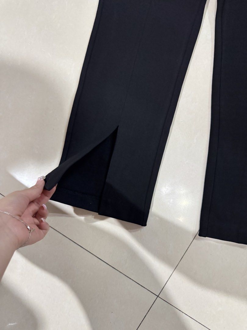 Black Split Hem Trousers Pants (Category: Jeans) located in Quezon City. Submitted by sweetlyluxe (Listing ID 1465490239, Image 2). Description: - Color: Solid black - Design: Front split hems at the ankles with structured center creases - Waist: Simple pull-on style for easy wear - Versatility: Perfect for office wear, casual days, or everyday outfits, corporate - Fit: Great fit and very easy to match with various tops and shoes.