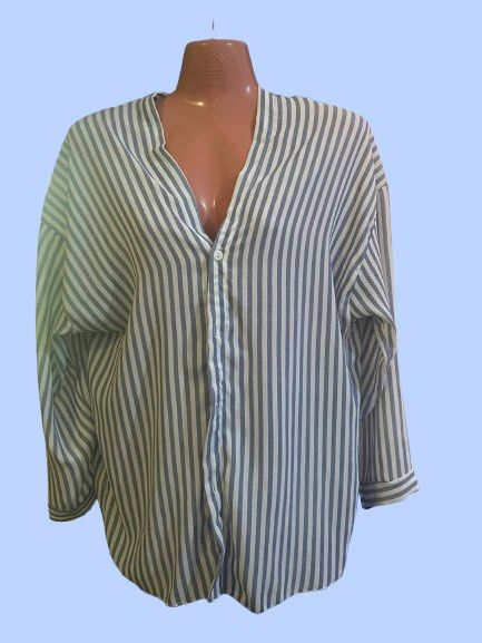 Blue and White Striped Long Sleeve Button-Down Blouse (Category: Longsleeves) located in Manila. Submitted by joclutter (Listing ID 1465400289, Image 1). Description: - Classic blue and white vertical stripe pattern - Oversized, relaxed fit with trendy drop shoulders - V-neckline with a chic single-button fastening - Long sleeves with fitted cuffs - Lightweight fabric that looks great tucked in or worn loose.