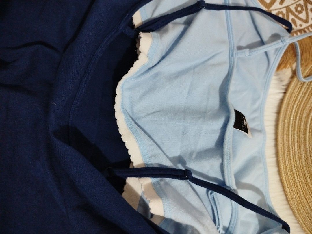 Blue camisole with built-in light blue inner layer (Category: Sleeveless) located in Quezon City. Submitted by plus4lessshop (Listing ID 1465441063, Image 2). Description: - Color: Navy blue with contrasting light blue inner layer - Details: Scalloped white trim along the neckline - Straps: Thin, adjustable straps on both inner and outer layers - Design: Unique double-layered style - Fit: Comfortable fabric, perfect for casual wear and layering.