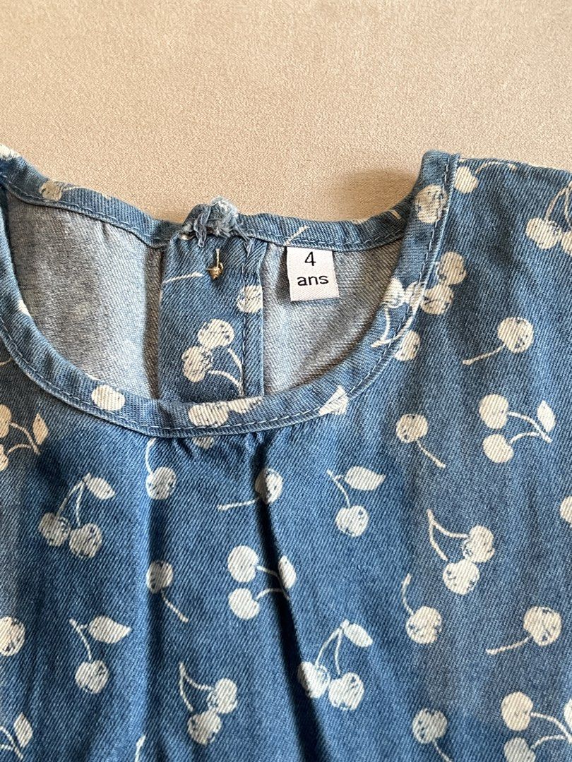 Blue Cherry Print Denim Dress (Category: Babies & Kids Fashion) located in San Fernando. Submitted by wearvfs (Listing ID 1465514184, Image 2). Description: - Adorable blue denim dress with all-over white cherry pattern - Size: 4 years (marked on tag) - Length: Approximately 58 cm Selling low, need to declutter.