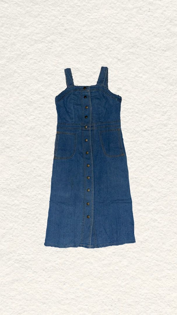 Blue Denim Button-Front Midi Pinafore Dress (Category: Dresses) located in Quezon City. Submitted by zealhorse_a9f3c3 (Listing ID 1465549444, Image 1). Description: - Style: Blue denim overall dress in a classic medium wash - Length: Midi length profile - Closure: Full front button placket - Details: Two front patch pockets at the hips and visible contrast stitching - Straps: Sleeveless style with comfortable thick straps -Defect: Upper and lower