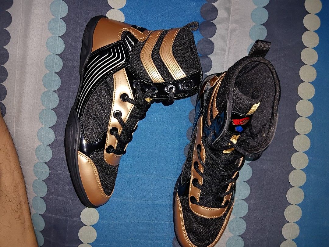 Boxing shoes (Category: Sneakers) located in Manila. Submitted by mightyforest_1ff6eb (Listing ID 1465482270, Image 3). Description: - Type: High-top athletic shoes for training, gym, boxing, or wrestling - Colors: Available in multiple colorways with stylish blue, black, and gold trims - Soles: Cushioned rubber soles with circular grip patterns for better traction - Support: Lace-up closure paired with a secure ankle strap - Comfort: Padded coll