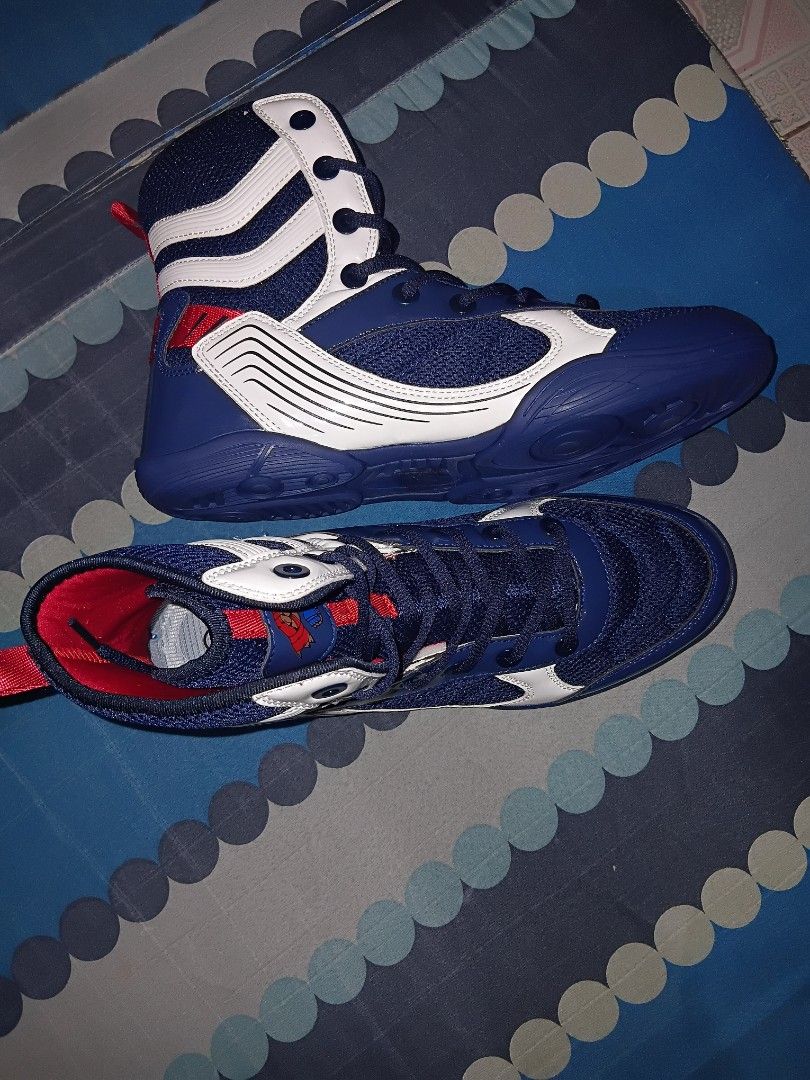 Boxing shoes (Category: Sneakers) located in Manila. Submitted by mightyforest_1ff6eb (Listing ID 1465482270, Image 1). Description: - Type: High-top athletic shoes for training, gym, boxing, or wrestling - Colors: Available in multiple colorways with stylish blue, black, and gold trims - Soles: Cushioned rubber soles with circular grip patterns for better traction - Support: Lace-up closure paired with a secure ankle strap - Comfort: Padded coll