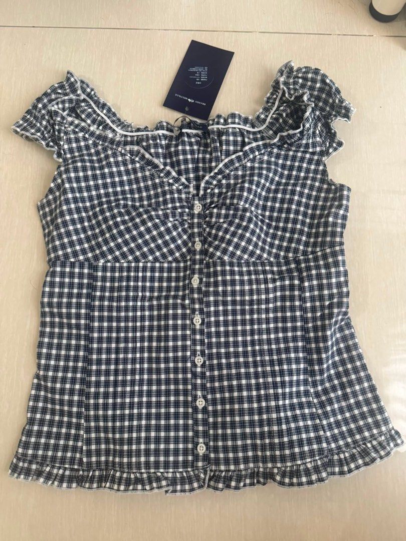 Brandy Melville Blue Elena Top (Category: Blouses) located in Manila. Submitted by wtheli (Listing ID 1465530496, Image 1). Description: - Brand: Brandy Melville - Pattern: Black and white gingham - Details: Sweetheart neckline, short ruffled cap sleeves, front button-down row, and ruffled hem - Style: Cottagecore, feminine, and trendy Used once, doesn’t fit me well Pasa bought from ig (lmk if u need more info :)).
