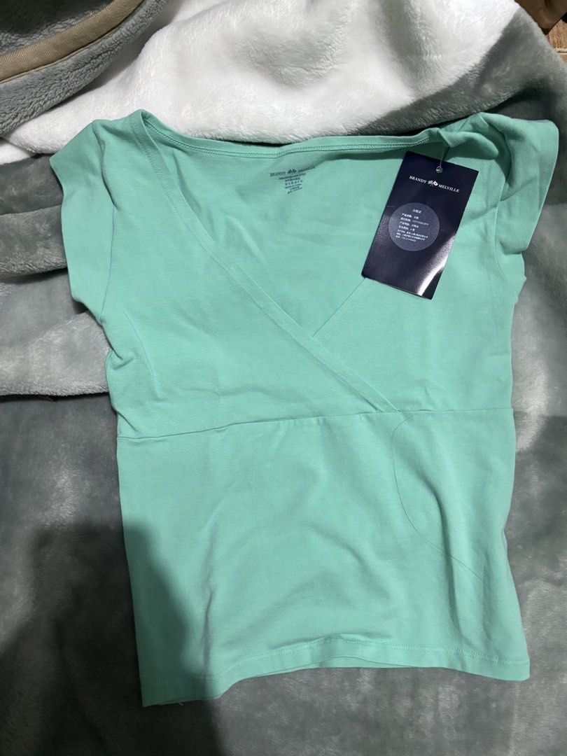 Brandy Melville Teal Amara Top (Category: Sleeveless) located in Urdaneta. Submitted by wishingunwell (Listing ID 1465490647, Image 3). Description: - Brand: Brandy Melville - Condition: Brand new with tags (BNWT), never worn - Color: Teal - Style: Wrap top with crossover v-neckline and short sleeves - Fit: Fitted style - Material: Soft and stretchy cotton blend RFS : Doesn’t fit me / Not my style also Just bought this, has tag AUTH.