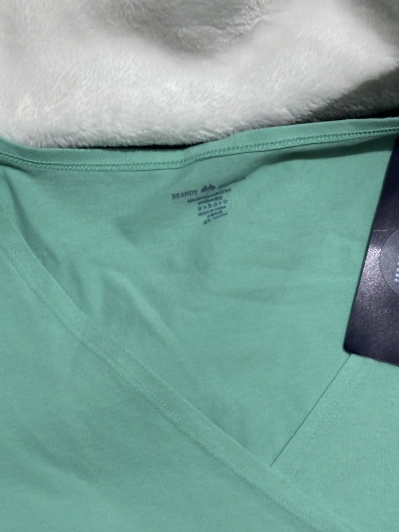 Brandy Melville Teal Amara Top (Category: Sleeveless) located in Urdaneta. Submitted by wishingunwell (Listing ID 1465490647, Image 2). Description: - Brand: Brandy Melville - Condition: Brand new with tags (BNWT), never worn - Color: Teal - Style: Wrap top with crossover v-neckline and short sleeves - Fit: Fitted style - Material: Soft and stretchy cotton blend RFS : Doesn’t fit me / Not my style also Just bought this, has tag AUTH.