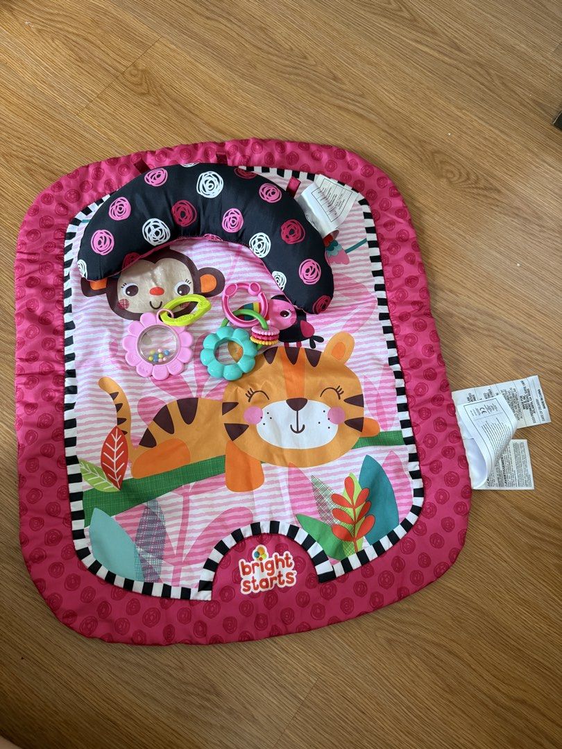 Bright Starts Wild & Whimsy™ Prop Mat (Category: Infant Playtime) located in Manila. Submitted by vydeleon (Listing ID 1465402596, Image 1). Description: - Brand: Bright Starts - Color/Theme: Pink with cute tiger and monkey design - Includes black and white patterned tummy time support pillow - Comes with matching colorful hanging teethers and bead rattle toys - Soft and comfortable fabric surface for infants - Perfect for daily tummy time and se