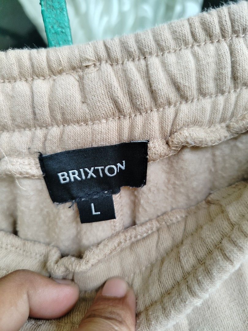 Brixton Sweatshorts Sand Size L (Category: Shorts) located in Manila. Submitted by gerald_quinto (Listing ID 1465470757, Image 3). Description: - Brand: Brixton - Item: Fleece sweatshorts - Color: Sand - Size: Large - Material: 60% cotton, 40% polyester with soft interior fabric - Features: Adjustable drawstring waist, functional side pockets, and small circular Brixton trademark supply graphic near the hem - Condition: Brand new / Excellent qual