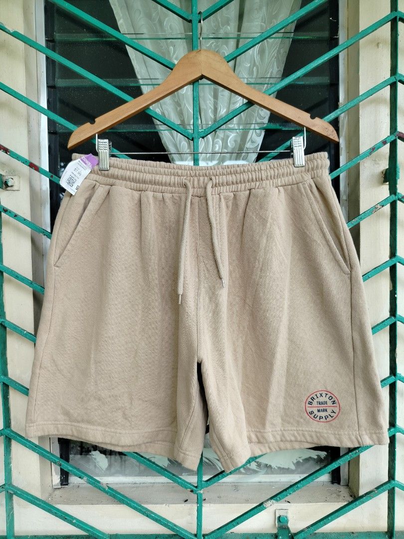 Brixton Sweatshorts Sand Size L (Category: Shorts) located in Manila. Submitted by gerald_quinto (Listing ID 1465470757, Image 2). Description: - Brand: Brixton - Item: Fleece sweatshorts - Color: Sand - Size: Large - Material: 60% cotton, 40% polyester with soft interior fabric - Features: Adjustable drawstring waist, functional side pockets, and small circular Brixton trademark supply graphic near the hem - Condition: Brand new / Excellent qual