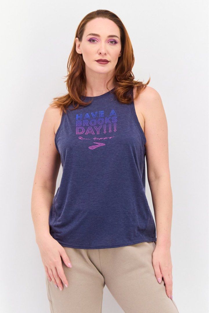 Brooks Running Top Size S (Category: Activewear) located in Rosales. Submitted by dariang22 (Listing ID 1465395131, Image 1). Description: - Brand: Brooks - Color: Heather blue - Size: S - Design: 'HAVE A BROOKS DAY!!!' graphic with Run Happy slogan and logo - Material: Lightweight, breathable athletic fabric - Fit: Relaxed fit with a comfortable racerback style - Condition: Excellent/Great for workouts and running.