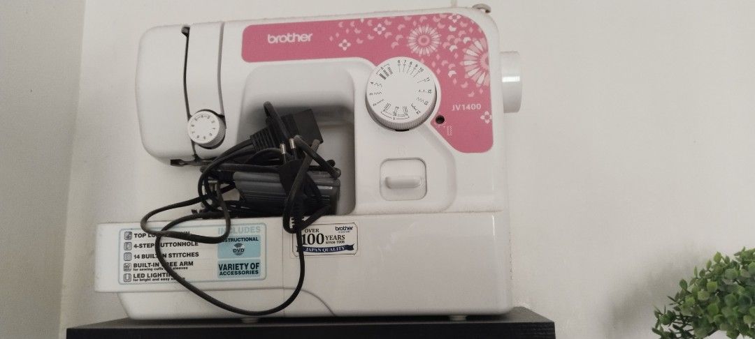 Brother JV1400 Sewing Machine with Threads and Rulers (Category: Craft Supplies & Tools) located in Candaba. Submitted by junoreyes52 (Listing ID 1465410222, Image 1). Description: - Model: Brother JV1400 Sewing Machine (White & Pink) - Included Hardware: Power cord and foot pedal - Thread Bundle: 5 boxes of Apple spun polyester threads - Extras: 2 sealed clear plastic sleeves with sewing rulers and grid templates - Condition: Great setup, perfec