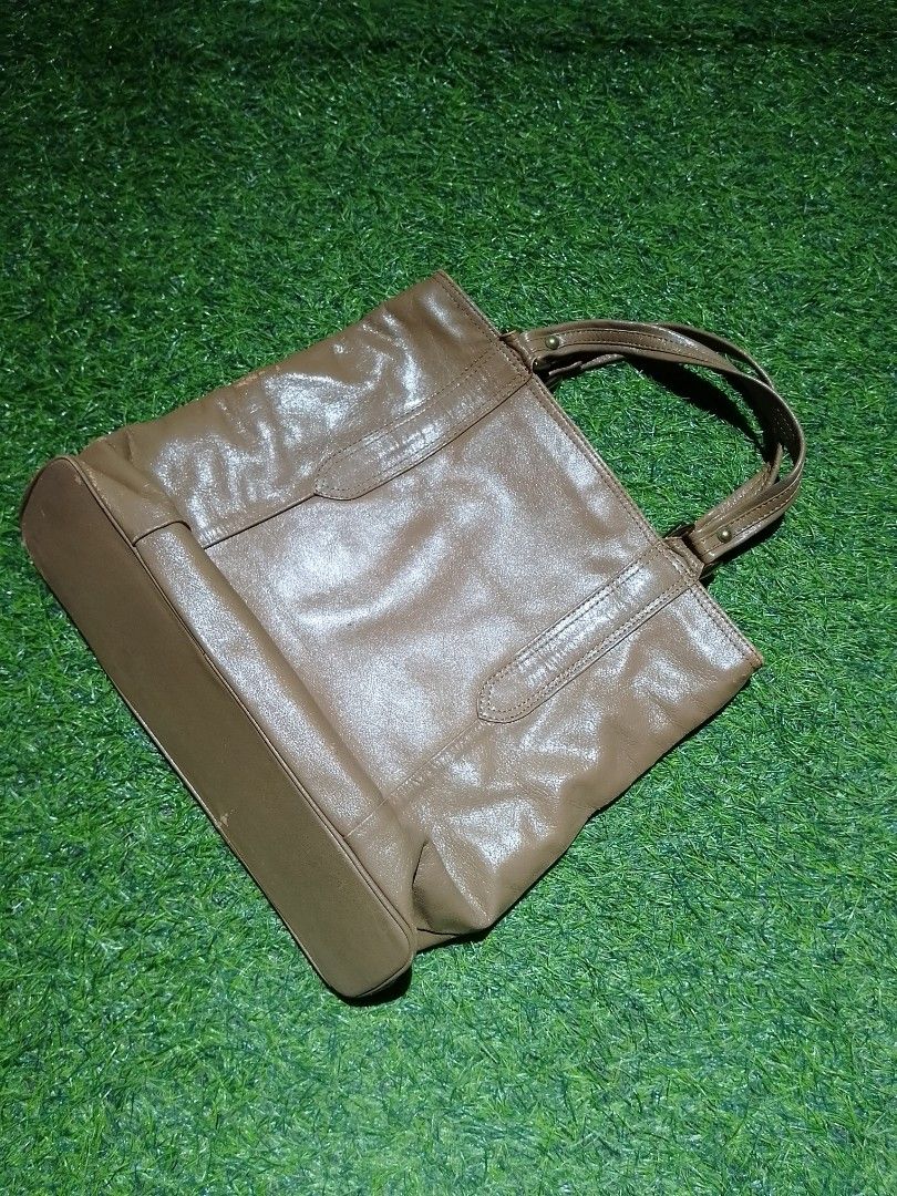 Brown Faux Leather Tote Handbag (Category: Tote Bags) located in Manila. Submitted by patrickjos06722 (Listing ID 1465501285, Image 2). Description: - Color: Brown - Design: Sturdy top handles with front stitched panel details and gold-tone hardware - Interior: Dark fabric lining with a secure zippered middle compartment divider - Structure: Flat, structured base panel helps the bag stand upright - Capacity: Spacious main compartment with plenty 