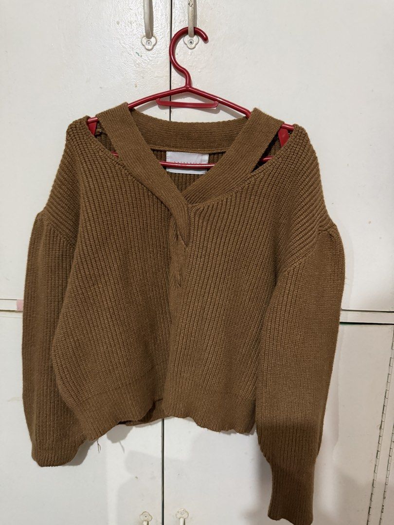 Brown knit sweater with shoulder strap detail (Category: Coats, Jackets and Outerwear) located in Mandaluyong City. Submitted by andreandlandicho (Listing ID 1465571391, Image 1). Description: - Color: Brown - Material: Warm knit fabric, perfect for cold weather - Design: Chunky ribbed texture with a trendy crossover strap neckline and bare shoulders - Fit: Cropped length with long sleeves and fitted cuffs - Styling: Versatile piece that looks gr