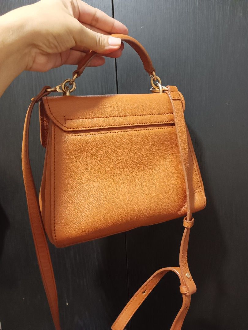Brown Leather Top Handle Bag with Shoulder Strap (Category: Luxury Bags & Wallets) located in Digos. Submitted by chihanu (Listing ID 1465440330, Image 3). Description: - Couronne brown leather bag - Top handle and detachable shoulder strap - Gold hardware detail on front clasp - Multiple interior compartments - Ideal for everyday use or dressing up an outfit.