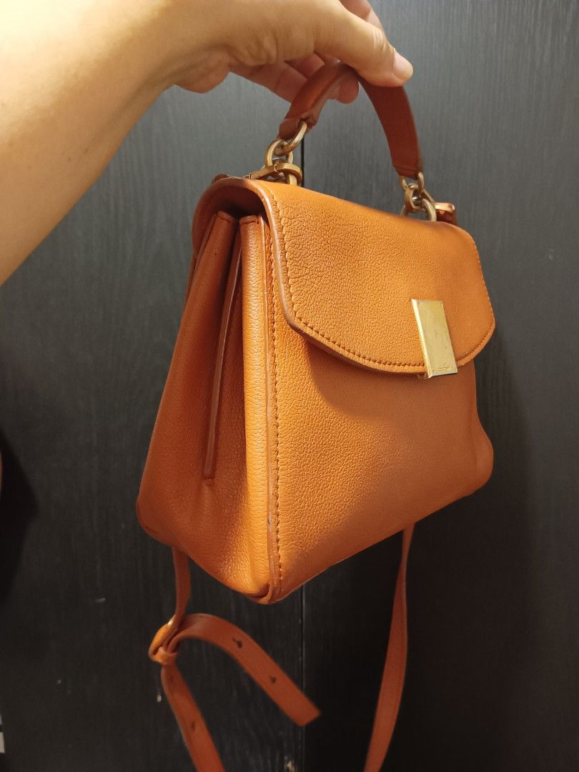 Brown Leather Top Handle Bag with Shoulder Strap (Category: Luxury Bags & Wallets) located in Digos. Submitted by chihanu (Listing ID 1465440330, Image 2). Description: - Couronne brown leather bag - Top handle and detachable shoulder strap - Gold hardware detail on front clasp - Multiple interior compartments - Ideal for everyday use or dressing up an outfit.
