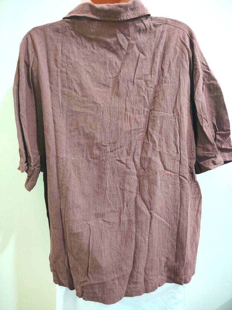 Brown Oversized Button-Down Shirt with Front Pockets (Category: Shirts) located in Quezon City. Submitted by timelesstreasure117 (Listing ID 1465553369, Image 3). Description: Can fit from small to large Good condition ₱35 Buyer books courier of choice Payment via gcash or paymaya.
