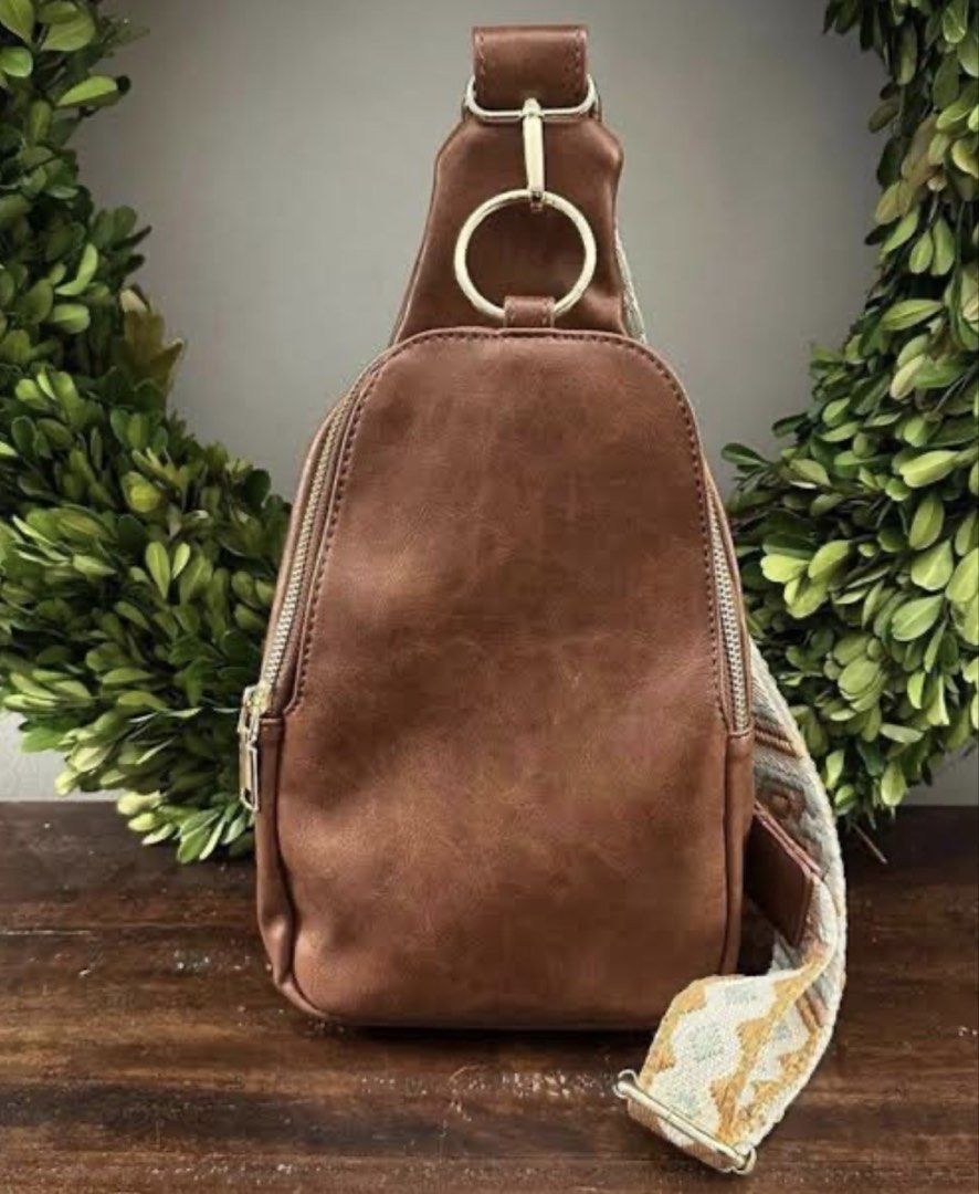 Brown Vegan Leather Sling Bag with Patterned Strap (Category: Cross-body Bags) located in Quezon City. Submitted by tflquezoncity (Listing ID 1465460923, Image 1). Description: ❤️ Excellent condition 10/10 no issues ❤️ Bought in the US 🇺🇸 ❤️Material: Brown vegan leather with clean interior lining ❤️Strap: Adjustable chunky guitar-style strap in beige, pink, and green geometric print ❤️Hardware: Gold-tone accents with a chic front ring detail ❤️