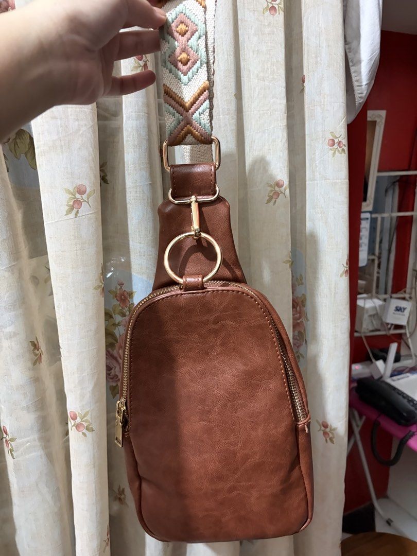 Brown Vegan Leather Sling Bag with Patterned Strap (Category: Cross-body Bags) located in Quezon City. Submitted by tflquezoncity (Listing ID 1465460923, Image 2). Description: ❤️ Excellent condition 10/10 no issues ❤️ Bought in the US 🇺🇸 ❤️Material: Brown vegan leather with clean interior lining ❤️Strap: Adjustable chunky guitar-style strap in beige, pink, and green geometric print ❤️Hardware: Gold-tone accents with a chic front ring detail ❤️