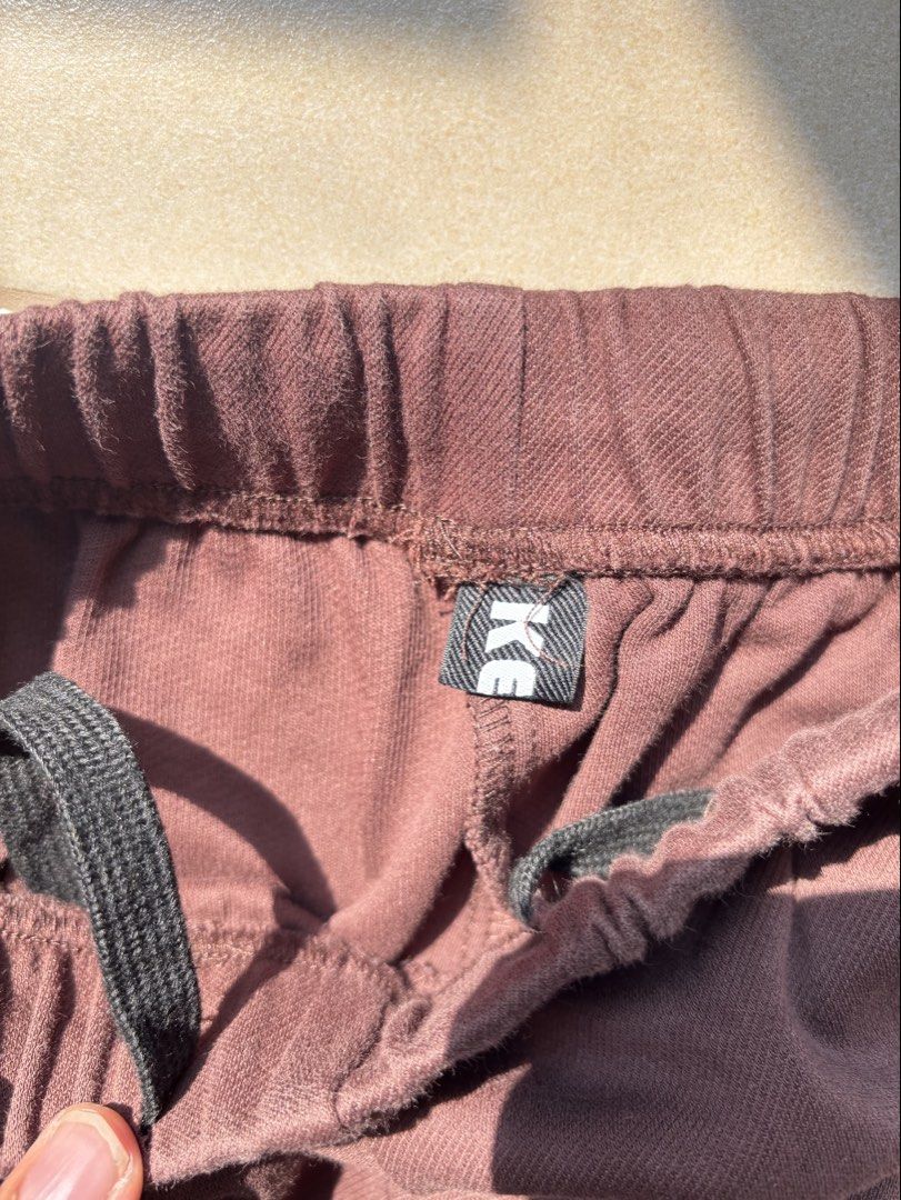 Brown track pants with white side stripes and drawstrings (Category: Joggers) located in Quezon City. Submitted by therealpaulsebastian.910 (Listing ID 1465391039, Image 2). Description: - Brown sweatpants with stylish vertical white stripes on outer legs - Comfortable elastic waistband for easy wear - Adjustable drawstrings at the hem for a customizable fit - Loose, relaxed fit through the leg - Perfect for casual streetwear and everyday comfort