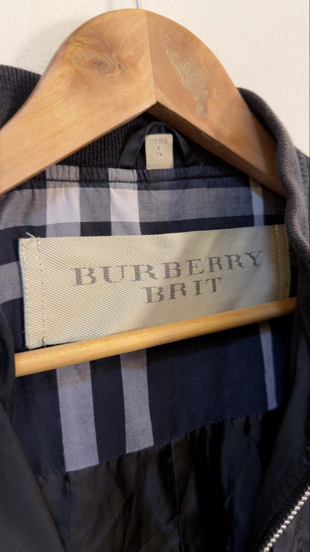 Burberry Brit Black Bomber Jacket (Category: Coats, Jackets and Outerwear) located in Paranaque City. Submitted by mykapoynton (Listing ID 1465547183, Image 3). Description: Burberry Brit Black Bomber Jacket - Color: Solid black - Size: 170/88A - Material: Lightweight polyester and nylon - Design: Full zip front, ribbed collar and cuffs, left sleeve zipper pocket - Detail: Classic Burberry check pattern inner lining.
