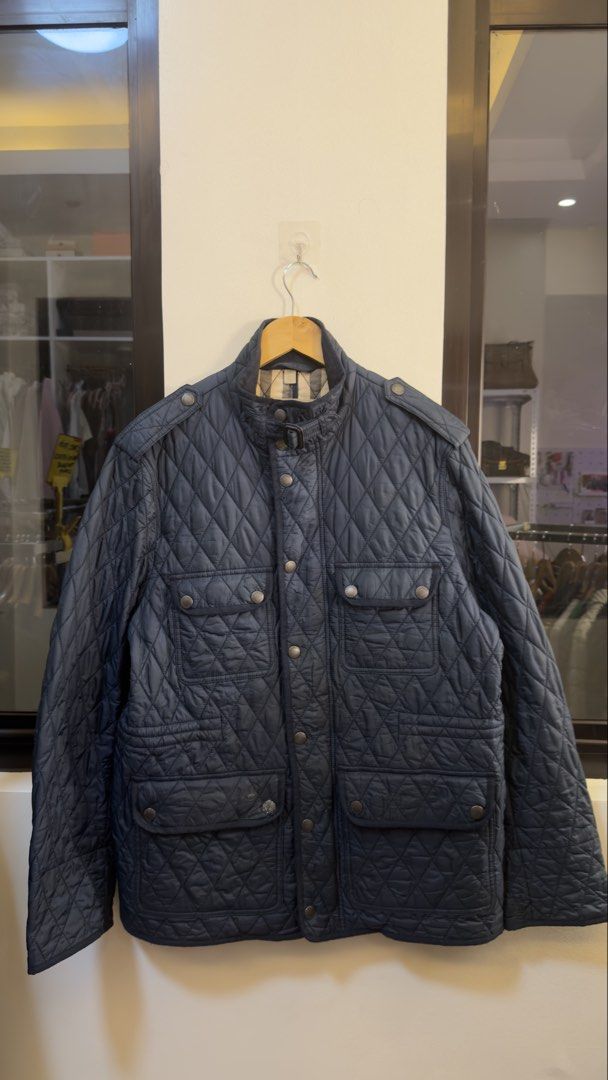 Burberry Brit Quilted Field Jacket Navy XL (Category: Coats, Jackets and Outerwear) located in Paranaque City. Submitted by preluxeshop_ph (Listing ID 1465550123, Image 2). Description: Burberry Brit Quilted Field Jacket Navy XL - Color: Navy Blue - Size: XL - Material: 100% Polyamide outer, Cotton & Polyester lining - Origin: Made in Thailand - Design: Classic diamond quilt pattern with iconic check lining - Details: Multiple front flap pockets,