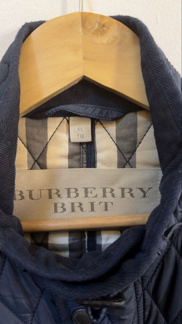 Burberry Brit Quilted Field Jacket Navy XL (Category: Coats, Jackets and Outerwear) located in Paranaque City. Submitted by preluxeshop_ph (Listing ID 1465550123, Image 3). Description: Burberry Brit Quilted Field Jacket Navy XL - Color: Navy Blue - Size: XL - Material: 100% Polyamide outer, Cotton & Polyester lining - Origin: Made in Thailand - Design: Classic diamond quilt pattern with iconic check lining - Details: Multiple front flap pockets,