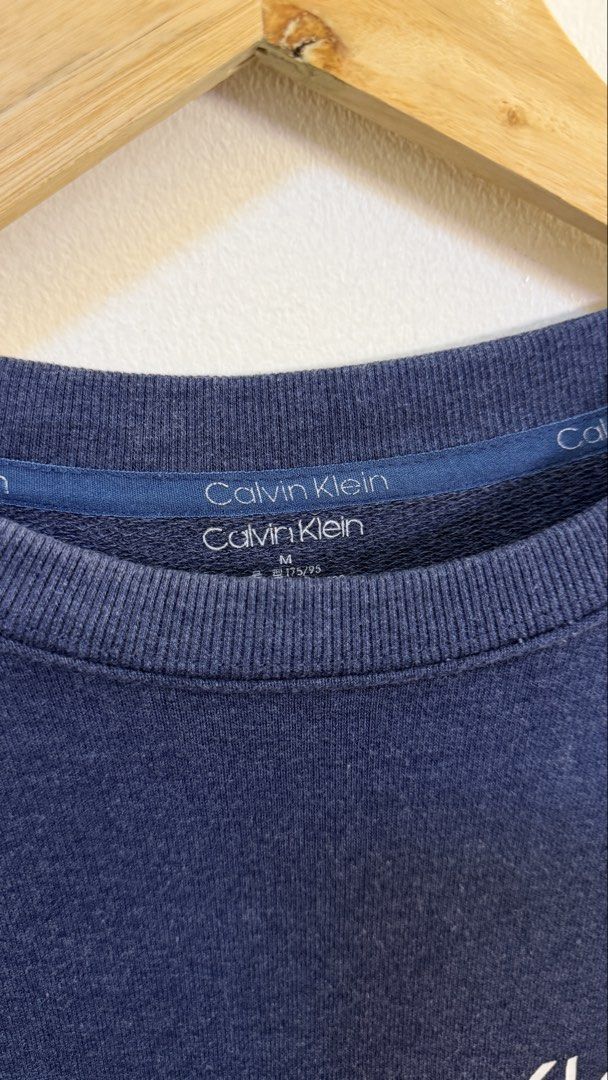 Calvin Klein Navy Blue Logo Sweatshirt Medium (Category: Coats, Jackets and Outerwear) located in Paranaque City. Submitted by preluxeshop_ph (Listing ID 1465558097, Image 3). Description: Calvin Klein Navy Blue Logo Sweatshirt Medium - Color: Navy blue with white chest logo - Size: M (175/95) - Material: Soft cotton blend - Fit: Classic pullover with ribbed cuffs and hem - Condition: Clean, excellent, and ready to wear 🔥CHECK OUT MY PROFILE FOR