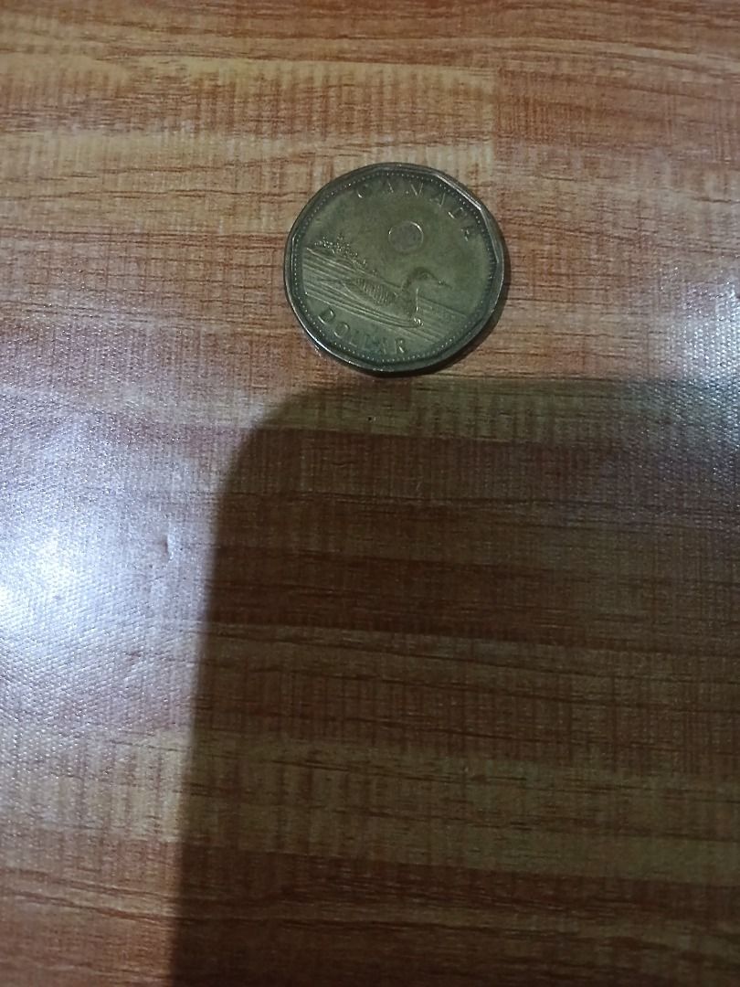 Canada One Dollar Coin Loonie (Category: Currency) located in Caloocan City. Submitted by vastdolphin.79423c (Listing ID 1465478075, Image 2). Description: - Authentic Canadian 1-dollar coin (Loonie) - Obverse features Queen Elizabeth II - Reverse features a loon swimming on water - Distinctive 11-sided golden-coloured design - Great addition to any world coin collection or foreign currency stash.