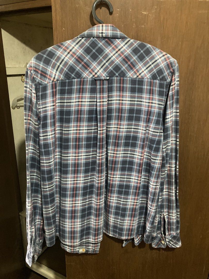 Carhartt Plaid Long Sleeve Button Down Shirt (Category: Tshirts & Polo Shirts ) located in Baguio. Submitted by joshhhhthrifted (Listing ID 1465434782, Image 2). Description: - Brand: Carhartt - Style: Long sleeve button-down shirt - Pattern: Classic plaid (blue, white, and red) - Fit: Regular fit - Condition: Excellent, no stains or tears - Ideal for: Casual everyday wear and layering.