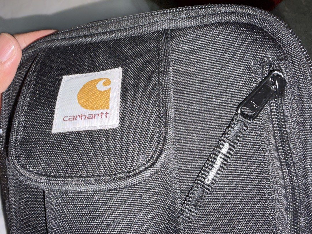 Carhartt WIP Essentials Bag Small Black (Category: Sling Bags) located in Manila. Submitted by ar-gee (Listing ID 1465505963, Image 2). Description: - Authentic Carhartt WIP Essentials Bag in solid black - Crafted from durable, heavy-duty polyester canvas - Multiple zippered compartments to keep your daily gear organized - Front pocket with secure Velcro flap closure and iconic woven Carhartt logo patch - Adjustable shoulder strap equipped with s
