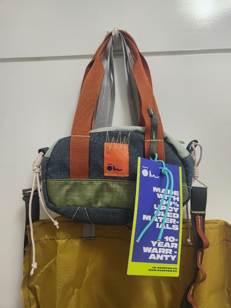 Carryom Kunti Bag (Category: Shoulder Bags) located in Makati City. Submitted by mikamix (Listing ID 1465383744, Image 2). Description: - Brand: Carryom Kunti Rebel - Design: Multi-color with denim, green, and orange details - Material: 90% upcycled materials - Condition: Brand new with tags, never used - Storage: Includes original yellow storage bag - Features: Secure zip closure top and convenient inner zipper pocket.