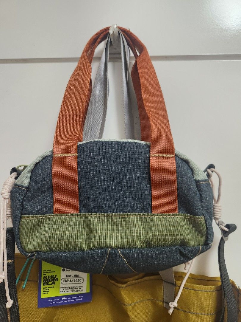 Carryom Kunti Bag (Category: Shoulder Bags) located in Makati City. Submitted by mikamix (Listing ID 1465383744, Image 3). Description: - Brand: Carryom Kunti Rebel - Design: Multi-color with denim, green, and orange details - Material: 90% upcycled materials - Condition: Brand new with tags, never used - Storage: Includes original yellow storage bag - Features: Secure zip closure top and convenient inner zipper pocket.